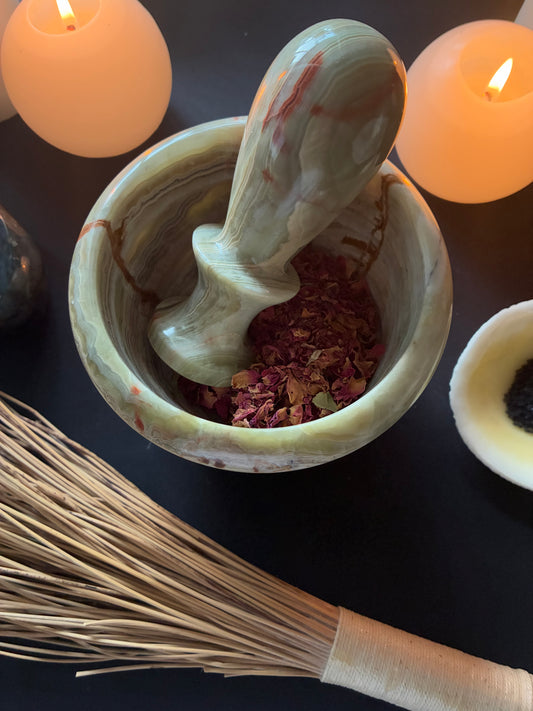 Green onyx mortar and pestle containing red rose petals - rosa gallica officinalis